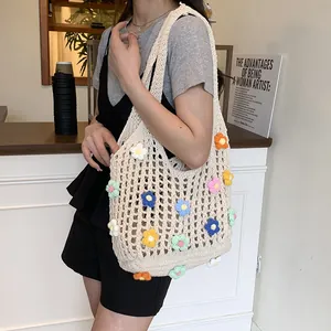 Chic cream hollow knit tote bag with colorful 3D crochet flowers on a model