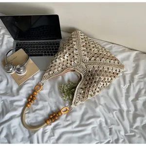 Detailed close-up of bohemian crochet tote bag featuring intricate woven patterns and wood beads