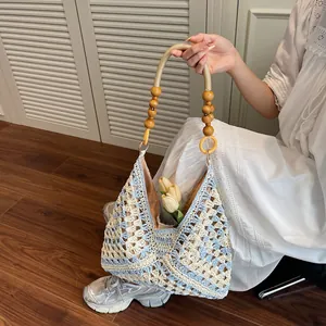Handcrafted woven tote bag with blue checkerboard pattern and wooden bead handles