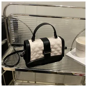 Détail du sac à main en cuir matelassé à carreaux avec fermoir en métal et poignée