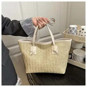 Large woven straw tote bag with cream PU leather handles for summer beach vacations