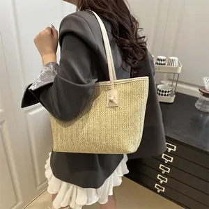 Fashionable woven straw tote bag with faux leather straps and large interior capacity