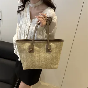 Fashionable straw tote bag with brown faux leather trim for summer beach and daily use