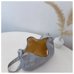 Close-up of metallic silver hobo bag with wide shoulder strap and spacious interior