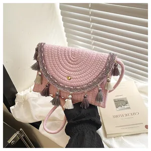 Bohemian pink straw woven saddle bag with colorful tassels and ethnic ribbon strap