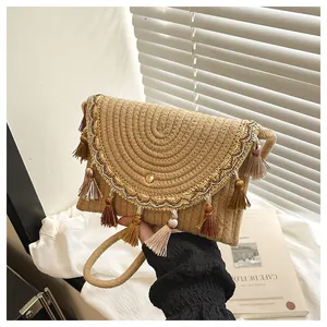Bohemian woven straw envelope bag with colorful tassels and metallic trim handle