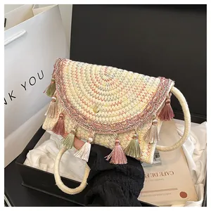 Straw woven crossbody bag with colorful fringe tassels in a luxury gift box packaging