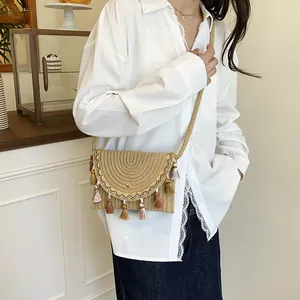 Bohemian straw woven crossbody bag with colorful tassels and golden embroidery detail