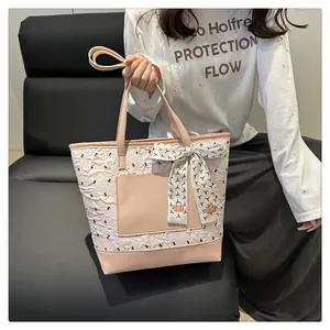 Detail of floral embroidery and polka dot ribbon on pink tote bag for women