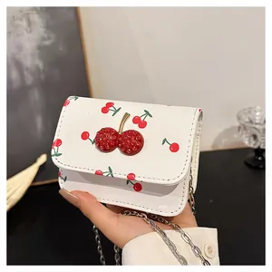 Detail of 3D crystal cherry buckle and floral pattern on mini chain shoulder bag