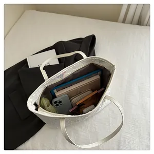 Interior view of spacious white tote bag showing storage for tablet and daily essentials