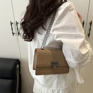 Chic brown woven texture crossbody bag with metal chain strap and geometric buckle