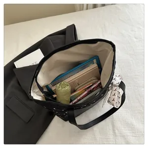 Internal view of a black quilted tote bag showing large capacity for daily essentials