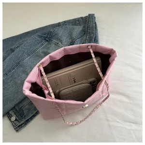 Internal view of pink quilted tote bag showing large capacity for books and phone