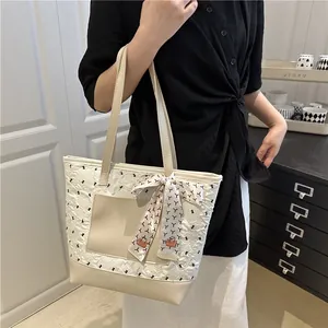 Chic beige pleated tote bag with smooth front pocket and decorative printed silk scarf
