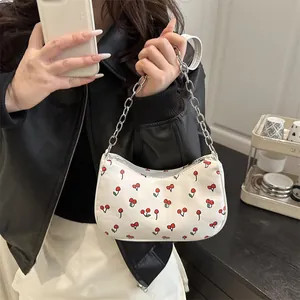 White faux leather underarm bag with red cherry prints and silver chain strap for women
