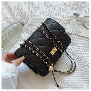 Close-up of black quilted shoulder bag featuring golden ball adjustment and turn-lock