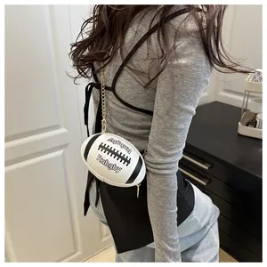 Close-up of rugby shaped handbag with letter print and golden chain strap