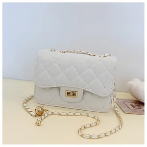 Detailed close-up of quilted cream shoulder bag featuring gold metal buckle and chain strap