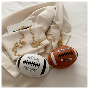 Detail of rugby-shaped leather crossbody bags with golden chain and sporty stitching