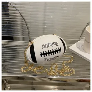 Detail of rugby-shaped crossbody bag with gold chain strap on a modern shelf