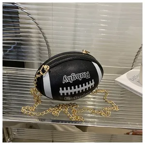 Detailed macro of a black rugby-shaped leather bag with white stripes and gold chain