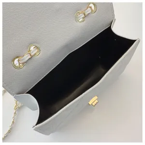 Top view of white quilted crossbody bag showing spacious interior and golden chain
