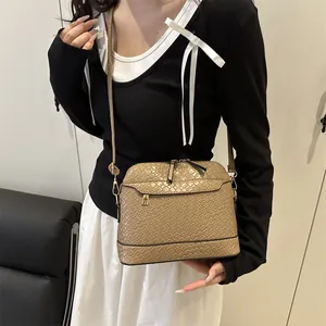 Khaki woven texture shell bag with adjustable shoulder strap and gold hardware accents