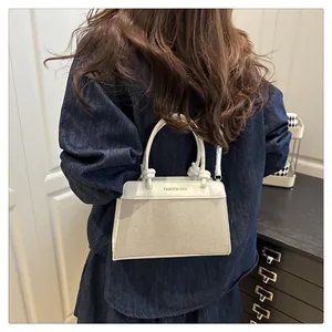 Detail of woven texture small tote bag with Fashion Bag text shown on shoulder