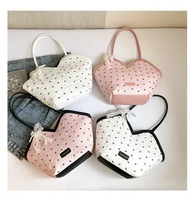 Detail of trendy bucket bags with cloud pleated texture and pearl lace bow charms