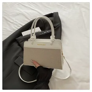 Close-up of color-block tote bag with woven texture and gold Fashion Bag lettering