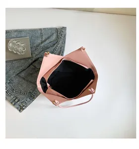 Close-up of the pale pink bucket bag interior featuring black lining and a zippered pocket