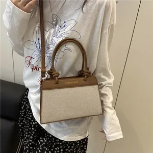 Chic color-block handbag with brown leather and beige textured panels for summer