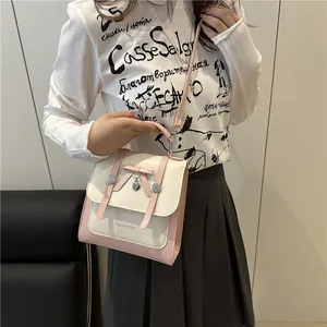 Japanese Harajuku style pink and beige crossbody bag with bow and heart charm on model