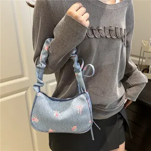 Light blue denim handbag with pink rose floral print and ruffled scrunchie strap