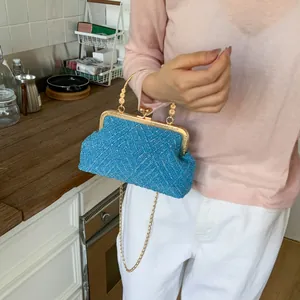 Blue woven tweed shell bag with gold clasp and chain strap for elegant evening parties