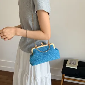 Detail of blue tweed purse featuring vintage gold clasp and delicate chain strap