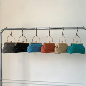 Selection of six shimmering evening clutch bags with metallic handles in diverse colors