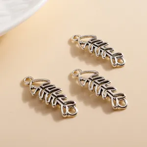 Close-up of vintage silver alloy fishbone charms with detailed skeletal structure for DIY