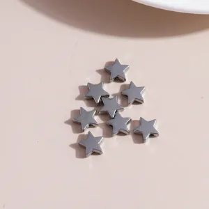 Close-up of star shaped alloy charms in antique silver finish for jewelry making
