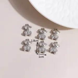 Macro detail of silver bear charms with precise dimensions for DIY jewelry making