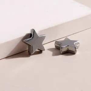Detailed macro view of star shaped metal charms with hole for DIY jewelry making