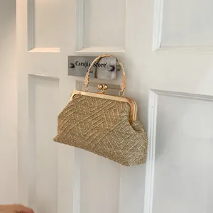 Detailed close-up of woven handbag with vintage gold metal frame and sunburst handle