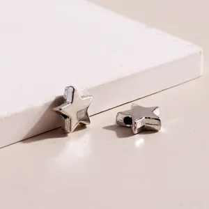Detailed view of antique silver star-shaped alloy beads for DIY jewelry making and crafts