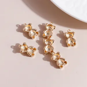 Macro view of 6 gold bear charms for DIY jewelry with detailed textured finish