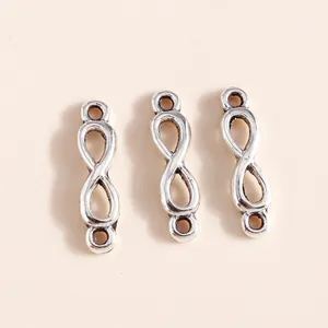 Macro shot of three antique silver infinity loop charms for DIY jewelry making