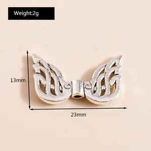 Macro detail of silver alloy wing pendant showing 23x13mm dimensions and 2g weight