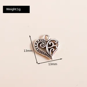 Close-up of 13mm hollow heart pendant in vintage silver alloy for DIY jewelry