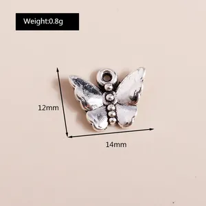 Macro view of vintage alloy butterfly pendant with dimensions 12mm by 14mm and 0.8g weight