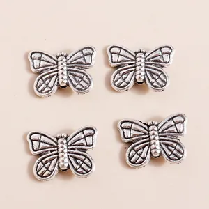 Detail of vintage silver butterfly charms with embossed wing textures for jewelry making